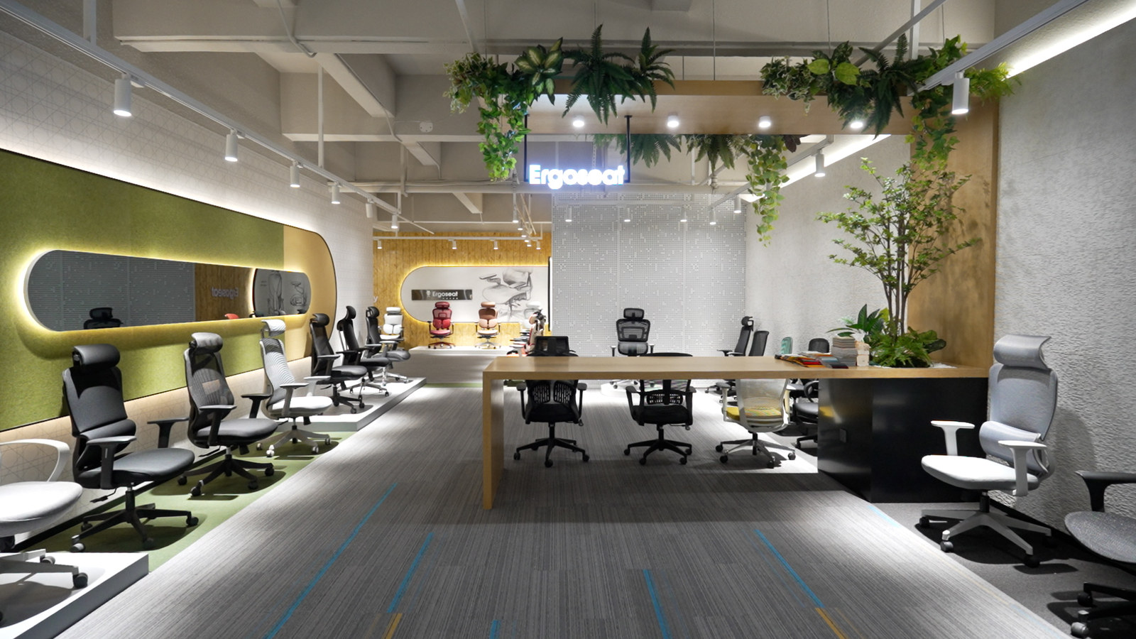 ErgoSeat showroom — chairs displayed along the wall beside the meeting area